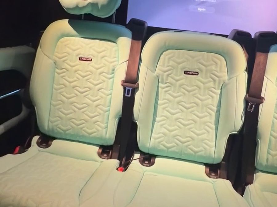 PS5 controller in hand with the screen on in the passenger cabin